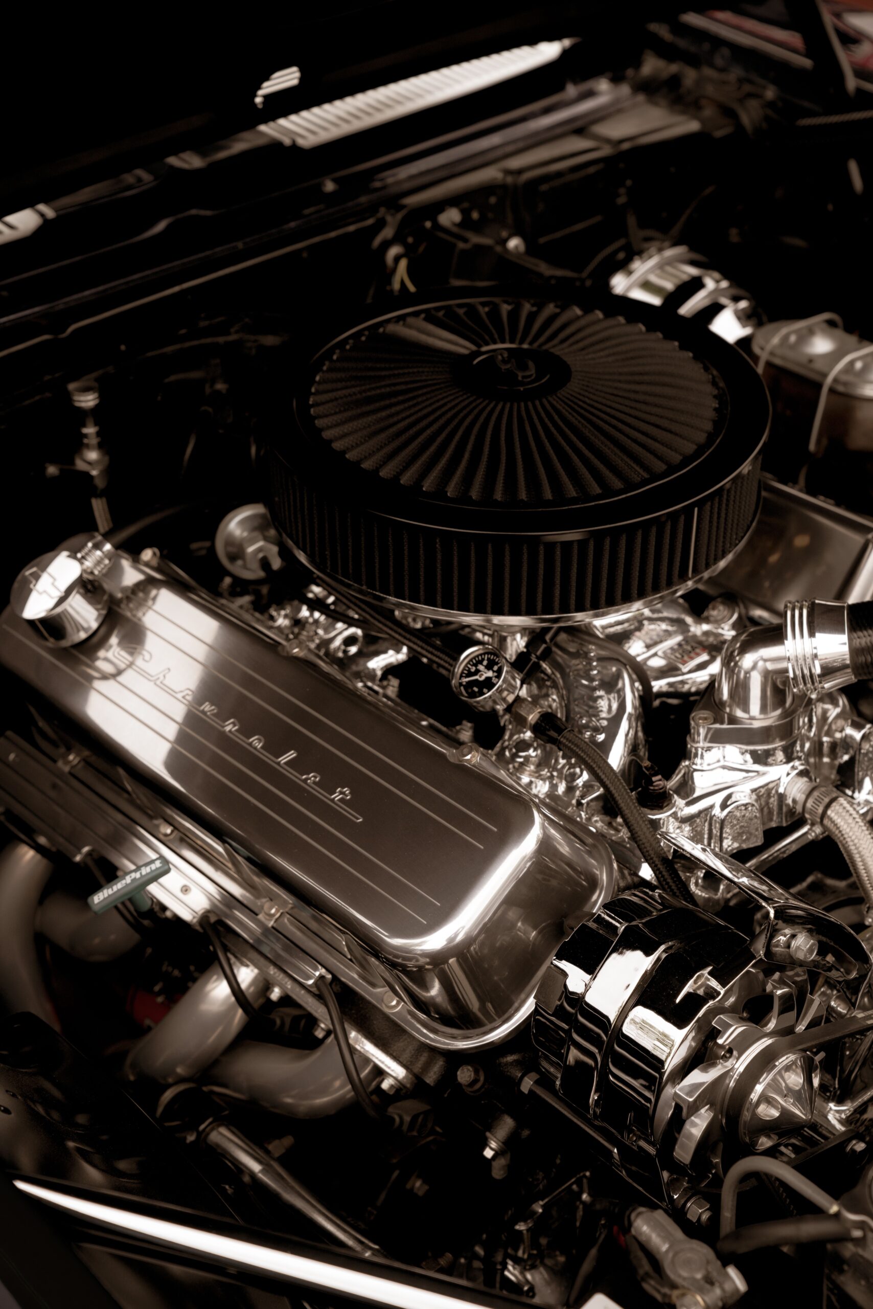 High-performance classic car engine with polished chrome components and performance air filter